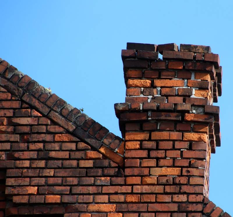 Damaged chimney on an Brookfield home showing cracks and missing mortar
